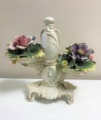 A Capo Di Monte ceramic model : Ornate clock with floral spray to each side, height 28 cm.