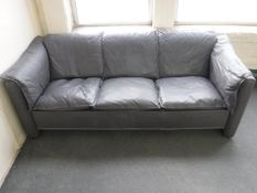 A mid twentieth century grey leather three seater settee