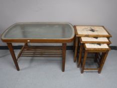 A mid 20th century Danish teak coffee table with glazed etched glass panel and a nest of three