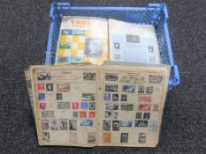 A basket containing eleven mid 20th century Trustey stamp albums and stamps