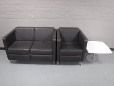 A leather two seater reception settee and armchair together with a white coffee table