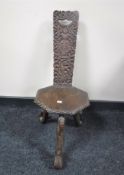 A carved Eastern hardwood spinning chair