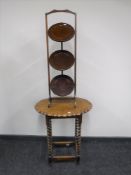 An oak pie crust edge occasional table and a three tier folding cake stand
