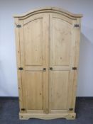 A pine arch topped double door wardrobe