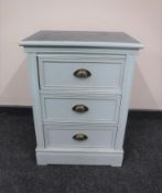 A painted three drawer bedside chest