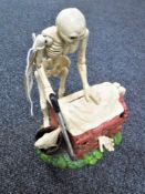 A cast iron skeleton money bank