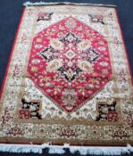 A Heriz carpet 230 cm x 160 cm on red ground