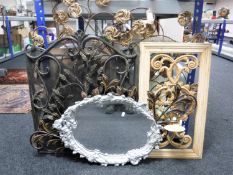 Two wicker wall fans, an ornate metal panel with candle sconce,