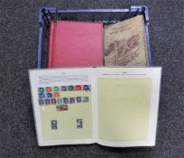 A basket containing six assorted mid 20th century stamp albums with stamps