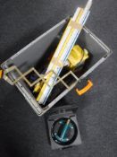 A box containing 110V transformer, spirit levels, pipe bender,