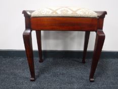 A mahogany piano stool