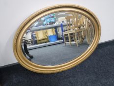 An early 20th century oval gilt framed bevelled mirror
