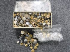A tin containing a large collection of military buttons