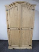 A pine arch topped double door wardrobe