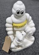 A cast iron Michelin figure and dog