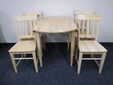 A contemporary pine drop leaf kitchen table and four chairs