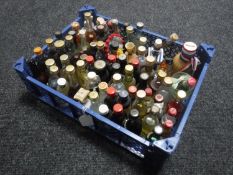 A basket containing approximately seventy-five alcohol miniatures