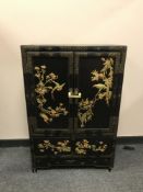 An Oriental style lacquered double door cabinet, width 61 cm.