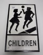 A cast iron children warning sign