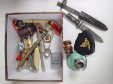 A box containing steward's badges, Zippo lighter, butter knives, letter opener,