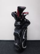 A Wilson golf bag containing a set of Wilson irons and drivers