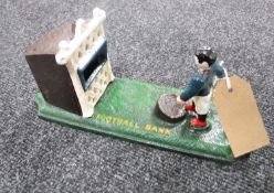 A cast iron football money bank