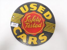 A cast iron used cars sign