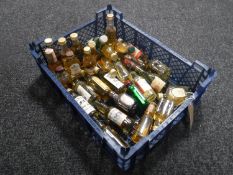 A basket containing approximately thirty assorted whisky miniatures