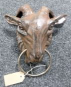 A cast iron goat head with ring