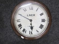 A circular oak cased wall timepiece,