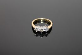 An 18ct gold three stone diamond ring,
