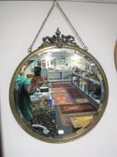An early 20th century circular brass framed bevelled mirror