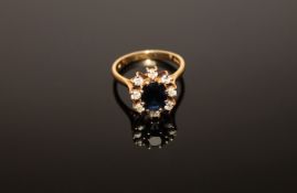 An 18ct gold sapphire and diamond cluster ring