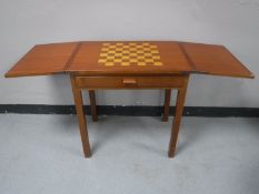 A mid 20th century inlaid mahogany games table