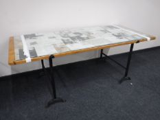 A pine glass topped trestle table on stand