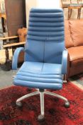 A blue leather adjustable office chair