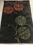 An Indian hand tufted rug with leaf design, 176 cm x 118 cm (rrp £297.00).