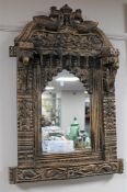 A carved Eastern style wall mirror