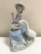 A Lladro figurine : Goose Trying to Eat, model 5034, height 25 cm, boxed.