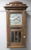 An Edwardian oak clock with calendar movement