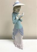A Lladro figurine : Lady Reading, model 5000, height 36 cm, boxed.