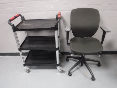 A swivel office armchair together with a plastic three tier trolley