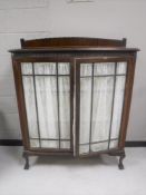 A Victorian mahogany double door display cabinet on claw and ball feet