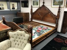 An impressive carved mahogany Gothic style 7' bedstead.