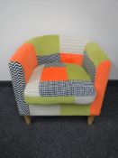 A contemporary tub chair upholstered in multi coloured fabric