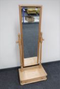 A pine cheval mirror fitted a drawer