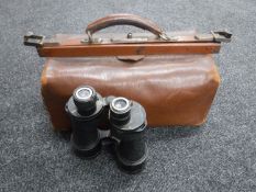 A leather doctor's bag together with a pair of field glasses
