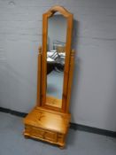 A pine cheval mirror fitted with a drawer