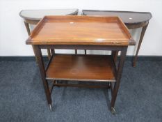 A mahogany two tier foldover games trolley,