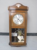 A 20th century mahogany cased Westminster chime wall clock with silvered dial